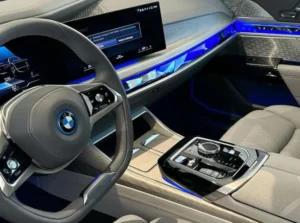 Interior of a modern BMW with illuminated dashboard and premium cabin features